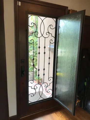 A dark brown door with an open glass pane