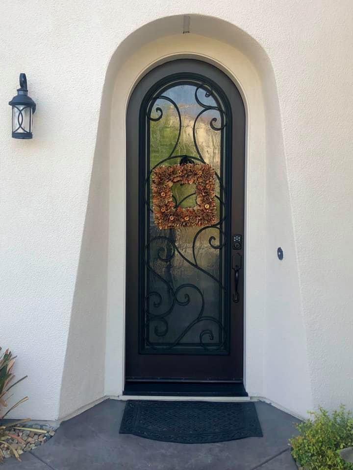 A door with a wreath on the front of it.