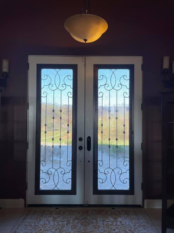 A pair of doors with glass panels on them.