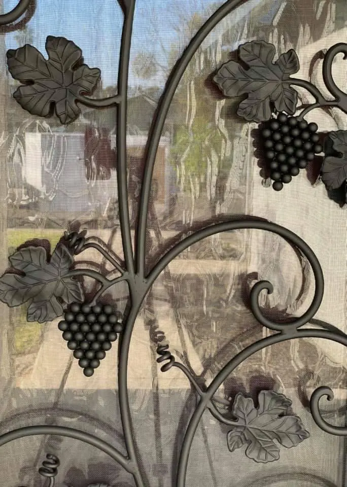 A closer look at the grape vine designs on the door
