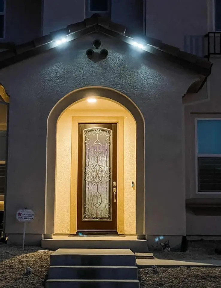 A door with a glass window and lights on the outside of it