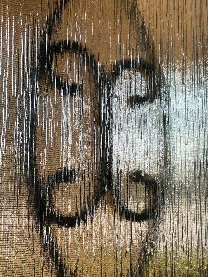A blurry image of the number 3 6 on a window.