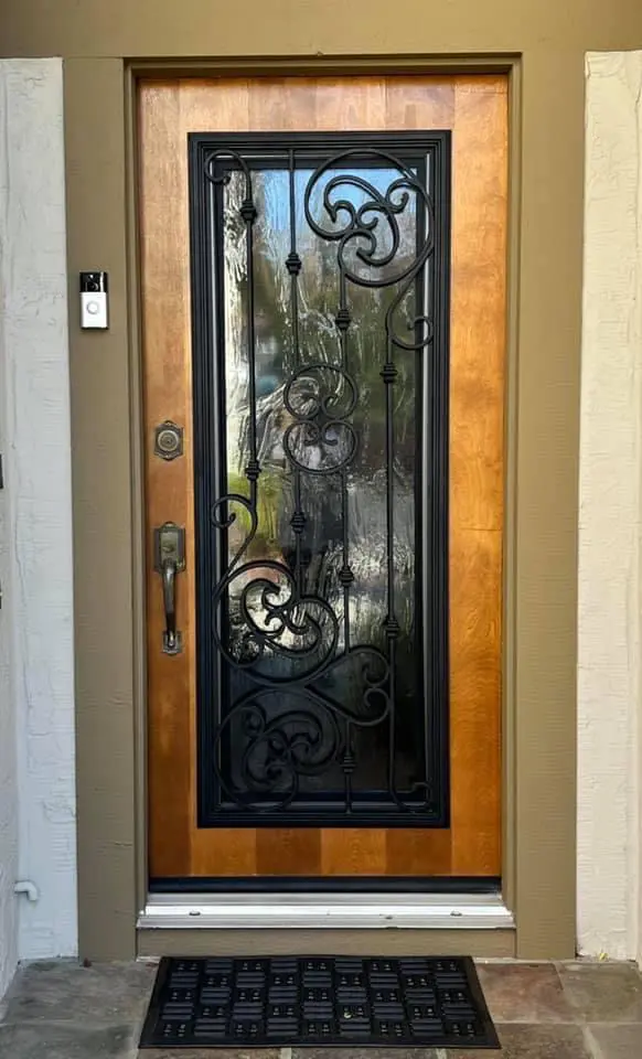 A wood and metal door with glass