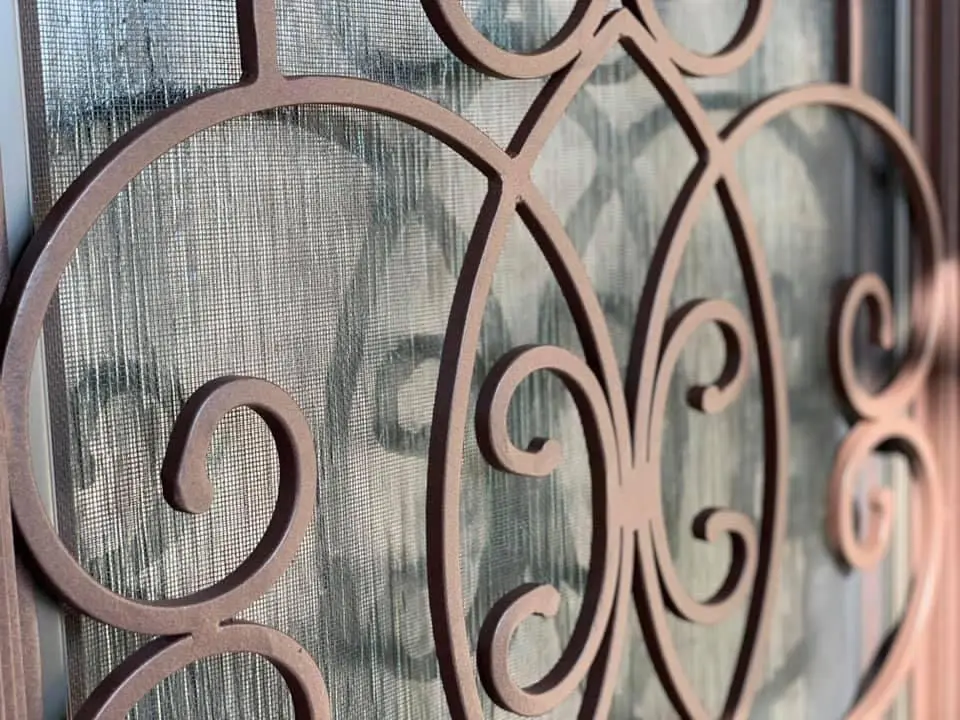 A close up of the iron work on the door.
