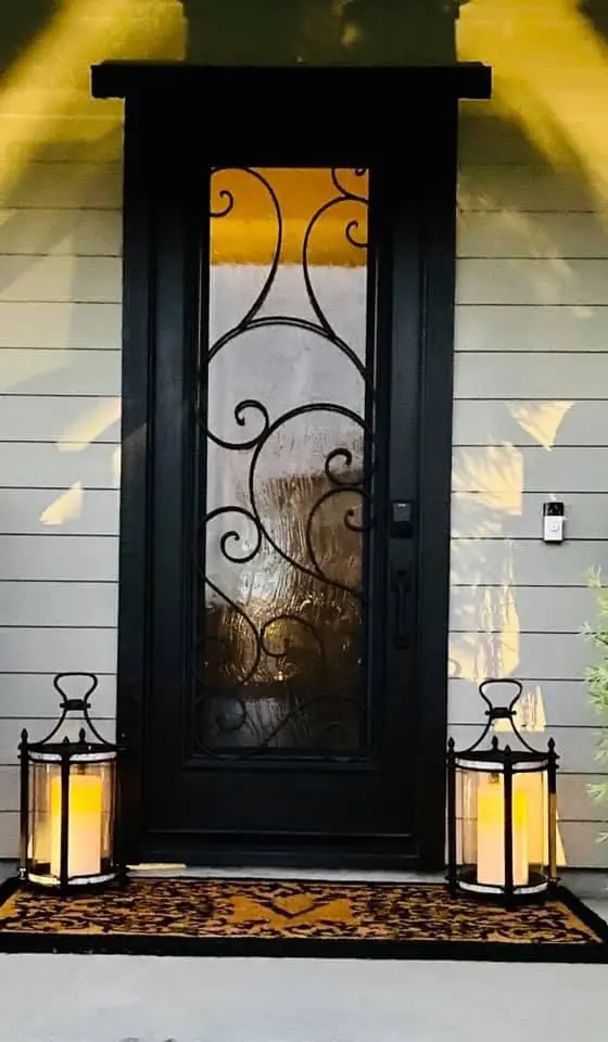 A black door with a glass window and a metal frame.